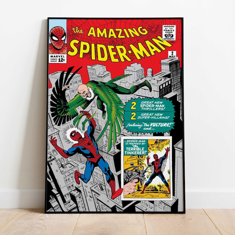 May include: A framed comic book cover of The Amazing Spider-Man, issue #2. The cover features Spider-Man in a red and blue suit battling the Vulture, a green-winged villain, above a cityscape. The comic is in a black frame.