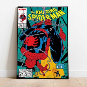May include: A framed comic book cover featuring Spider-Man in a dynamic pose. The artwork showcases Spider-Man in a red and blue suit, with the title "The Amazing Spider-Man" in yellow. The background is a mix of teal, yellow, and black.