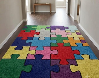 May include: A rectangular area rug featuring a multi-colored puzzle piece pattern. The rug is composed of interlocking segments in vibrant shades of red, blue, green, yellow, purple, pink, orange, and light gray, each outlined in black.