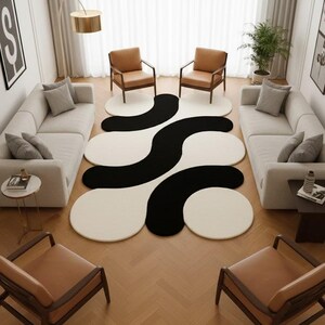 May include: A modern living room featuring a large, abstract rug with a black and white wavy design. Two matching sofas face each other, with two brown leather chairs in front of each sofa. The room has a neutral color palette with a gold floor lamp.