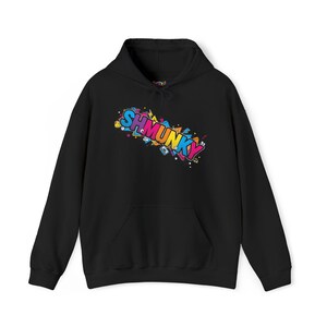 May include: Black hoodie with a front pocket and a drawstring. The front of the hoodie displays the word "SHMUNKY" in a vibrant, graffiti-style design. The design incorporates various geometric shapes and a range of bright colours.