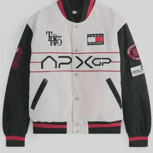 May include: White and black varsity jacket with red accents. Features the Tommy Hilfiger logo, the text "T85", and the letters "APXGP". The jacket has black sleeves and red and black striped cuffs and collar.