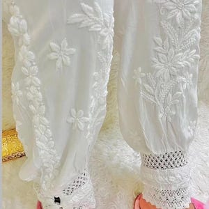 Traditional white cotton afghani harem pants with elastic waist and lace cuffs