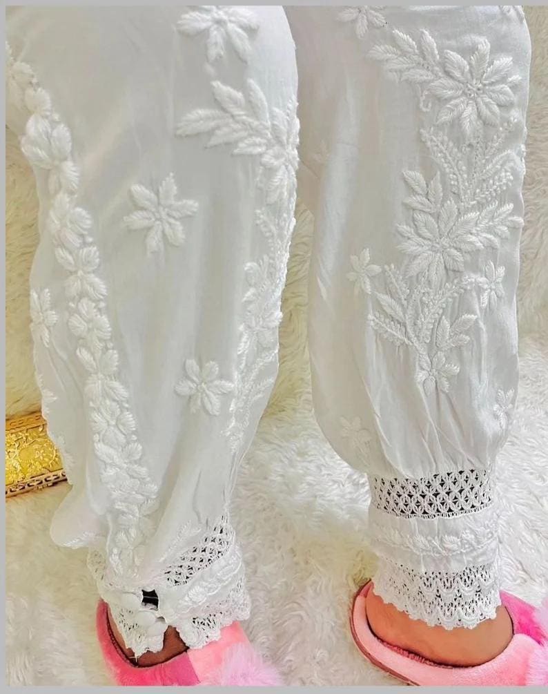 Traditional white cotton afghani harem pants with elastic waist and lace cuffs