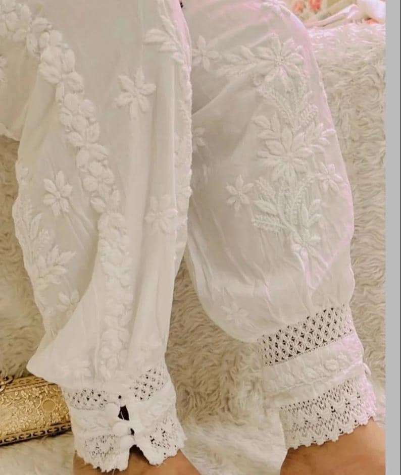 White cotton afghani pants with chikankari embroidery and lace ankle detailing