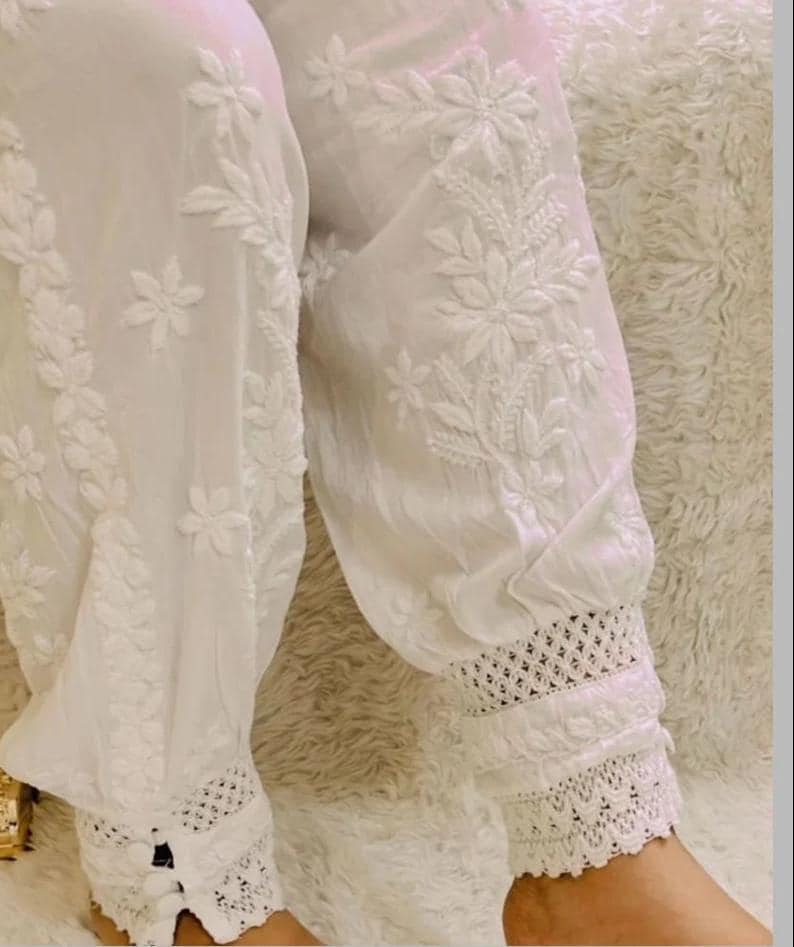 Women’s white cotton afghani pants featuring floral chikankari work