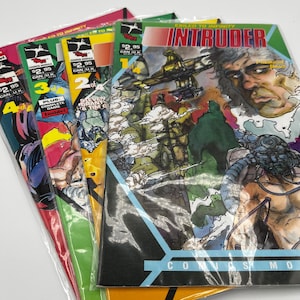 May include: A stack of comic books in plastic sleeves. The covers feature colorful illustrations and text, including the title "INTRUDER" and numbers 2, 3, and 4. The comics are in various colors, including red, green, and yellow.
