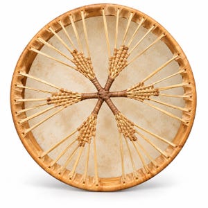 May include: A circular frame drum featuring a light tan, textured drumhead stretched across a wooden hoop. The back is secured with thin, light-colored strips of material woven into a star-like pattern that meets at the center.