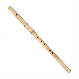 May include: A light brown bamboo flute with several finger holes and a silver-coloured band. The flute is angled diagonally across a white background. The instrument has a smooth, polished finish.