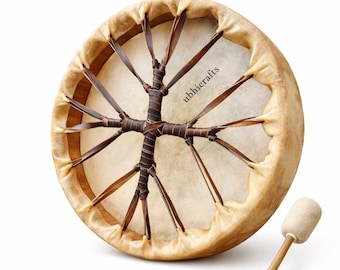 May include: A round frame drum with a light-coloured animal hide head and a wooden frame. Dark brown leather lacing forms a cross-like pattern in the centre. The text ubhicrafts is printed on the drum head. A wooden mallet with a soft head is included.