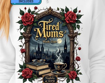 May include: White sweatshirt featuring a design with the text "Tired Mums Book Club" above a nighttime cityscape scene. The design includes roses, books, a teacup, and the text "Nightly at 10 PM". The sweatshirt also includes the text "FREE 6 DESIGNS INCLUDES".