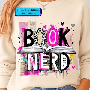 May include: Beige sweatshirt with a graphic design that reads "BOOK NERD" in black, pink, and white. The "O" in "BOOK" has a leopard print design. The design includes an open book, hearts, and the text "FREE 6 DESIGNS INCLUDES".
