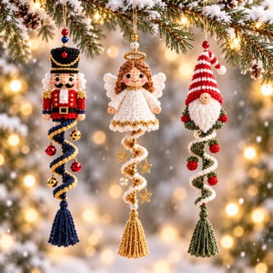 May include: Three crocheted hanging ornaments featuring a nutcracker in red and blue, an angel in white with a gold halo, and a gnome with a red and white striped hat. Each ornament has a spiral tail with small decorative beads, stars, and tassels.