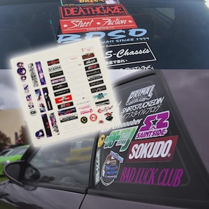 May include: A selection of stickers featuring text and graphics, such as "DEATHGAZE", "Street Faction", and "BAD LUCK CLUB". The stickers are shown on a car window and a sheet.