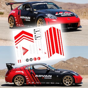 May include: Black and red sports car with gold alloy wheels, displaying "ADVAN" and "YOKOHAMA" branding. The car has a rear spoiler and sponsor decals. A sheet of red and white decals is in the foreground. The car is on a road.