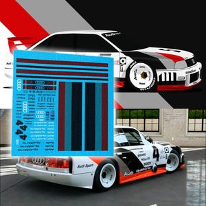 May include: A graphic of a white Audi Quattro race car with red, black, and grey details. A blue sticker sheet with racing stripes and logos is in the foreground. The car features the number 4 and the words "Audi Sport".