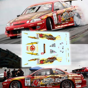 May include: A decal sheet featuring various graphic designs, logos, and text including TandE co., ltd, Vertex, and Gran Turismo, intended for a red drift car. The sheet contains yellow lightning bolts, sponsor logos, and racing numbers on a light blue background.
