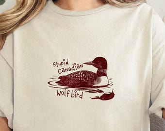 バカなカナダオオカミ鳥のTシャツ、面白いアビのミームグラフィックTシャツ