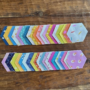 May include: A white ceramic mug with a black handle and the text "But First, Coffee" in a handwritten style. The mug is on a white surface. The mug is approximately 4 inches tall.