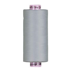 May include: A spool of light gray thread with the text "Efil Eina Col" and "an Cotton 60" printed on the pink labels. The thread is tightly wound and cylindrical, suitable for sewing and crafting projects.