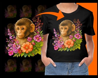 May include: Black t-shirt with a detailed illustration of a monkey surrounded by colourful flowers. The monkey has brown fur and is centered on the shirt, with vibrant pink, orange, and purple flowers framing it.