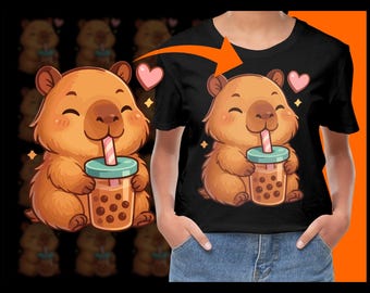 May include: Black t-shirt featuring a cartoon capybara drinking bubble tea. The capybara is brown with a light brown face and is holding a cup of brown bubble tea with a pink and white straw. Pink hearts and sparkles are also in the design.