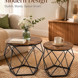 May include: Two round nesting tables with dark brown wood-grain tops and black geometric metal wire bases. The text Modern Design, Stylish. Sturdy. Space-Smart. is visible at the top. A glass vase with flowers and a book sit on the larger table.