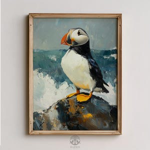 May include: Oil painting of a puffin bird perched on a rock, set against a backdrop of ocean waves. The bird has a white chest, black back, and a large orange and yellow beak. The painting is in a gold frame.