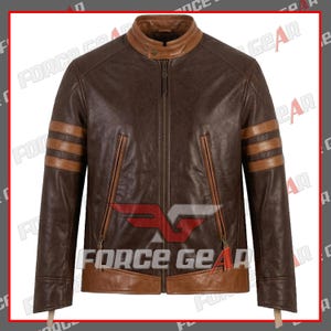 Può includere: Una giacca in pelle marrone scuro con colletto in pelle color cuoio chiaro, orlo in pelle color cuoio abbinato e due strisce orizzontali in pelle color cuoio su ogni manica. La giacca presenta una chiusura centrale con zip e due tasche verticali.