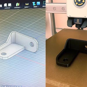 May include: A black, L-shaped bracket with two circular holes, next to a computer rendering of the same bracket. The bracket is on a brown surface, and the computer screen shows a 3D model of the bracket.