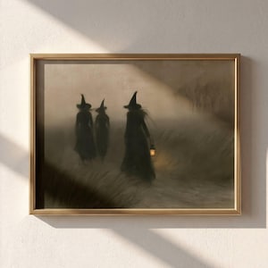 May include: A framed wall art print depicting three silhouetted figures wearing pointed hats walking through a foggy, grassy field. The central figure holds a glowing lantern that casts a warm light, while the overall color palette is muted brown.