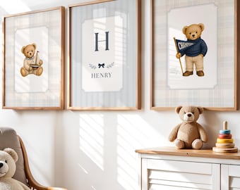 May include: Three framed wall art prints featuring teddy bear illustrations and the name Henry, displayed above a white cabinet with a wooden top. A rattan armchair with a plush teddy bear, a small bear-faced floor cushion, and wooden toys.
