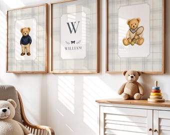 May include: Three framed wall art prints featuring two teddy bears and a central monogram with the letter W and the name William, displayed above a white cabinet with a wooden top, a plush teddy bear, and a wooden stacking toy.