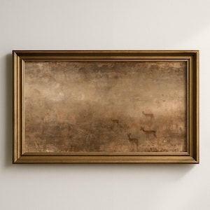 May include: A rectangular landscape painting in a metallic gold frame featuring a muted brown and beige scene of several deer standing in a hazy, textured field. The artwork displays a soft, weathered appearance with subtle variations in tone.