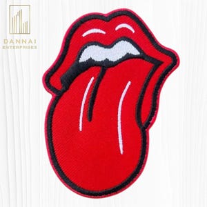 May include: Embroidered patch featuring the iconic Rolling Stones tongue and lips logo. The patch is primarily red with a black outline and white accents. The patch is a popular item for clothing and accessories.