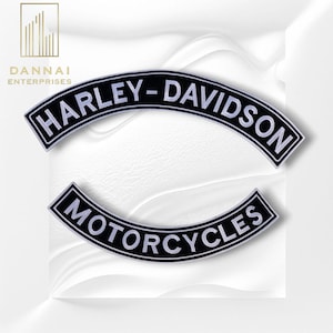 May include: Two black and white Harley-Davidson motorcycle patches. The top patch reads "HARLEY-DAVIDSON" in white, arched text. The bottom patch reads "MOTORCYCLES" in white, arched text. The patches are on a white background.