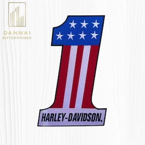 May include: Embroidered patch in the shape of the number one. The top portion is blue with white stars, and the bottom is red and white stripes. The text "HARLEY-DAVIDSON" is at the bottom.