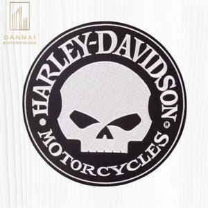 May include: A circular black and white patch featuring the Harley-Davidson Motorcycles logo. The design includes a white skull in the center, surrounded by the brand name in a circular pattern. The patch also includes the text "DANNAl ENTERPRISES".