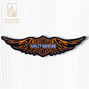 May include: A black and orange Harley-Davidson Cycles patch with a wing design. The patch features the words "MOTOR HARLEY-DAVIDSON CYCLES" in white and orange. The patch is embroidered with orange thread and has a black border.