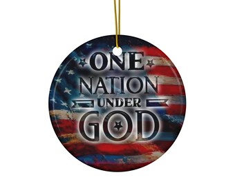 May include: Round ceramic ornament featuring the American flag design with the text "ONE NATION UNDER GOD" in white. The ornament has a gold string for hanging. Patriotic themed.