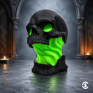 May include: A matte black skull sculpture featuring a vibrant neon green interior that glows through the eye sockets and the neck area, which is depicted as a swirling, fluid column of bright green material connecting the cranium to the jaw.