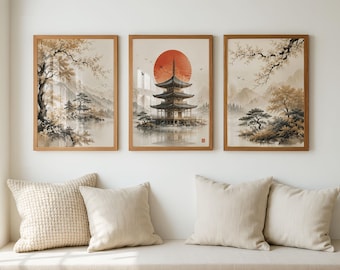 May include: A set of three framed wall art prints featuring a central pagoda structure under a large red sun, flanked by two landscape scenes with trees, mountains, and water in muted brown, beige, and black tones on a light background.
