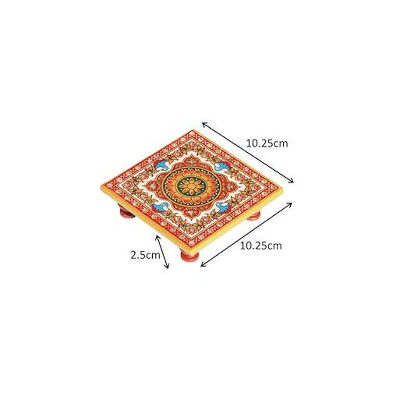 May include: A square wooden pedestal with a colourful floral pattern in red, orange, green, and blue. The stand features four small red feet and measures 10.25 cm by 10.25 cm with a height of 2.5 cm as indicated by the dimension lines.