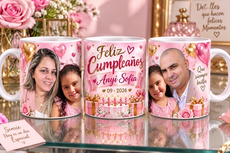 May include: A white ceramic mug featuring a pink birthday theme with gold and pink heart balloons, a cake with candles, and gift boxes. The text reads Feliz Cumplea&ntilde;os, Anyi Sofia, 09-2026, and Que siempre brilles. The mug displays two different family photos.