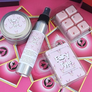 May include: A set of pink and white fairy-themed wax melts, a pink and white fairy-themed room spray, and a pink and white fairy-themed card with the text "Fairy Type" and "Strawberry Soda Scented".