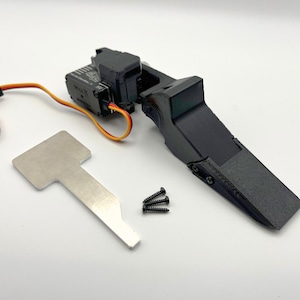 May include: A collection of black and silver mechanical parts, including a black servo motor, a silver metal plate, and three small black screws. A multi-coloured wire is connected to the servo motor.