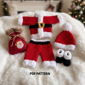 May include: A crochet Santa Claus outfit consisting of a red and white jacket with a black belt, matching red and white pants, a red and white hat with a pom-pom, and black booties. A red drawstring bag with a Santa patch is included. Text reads PDF PATTERN.
