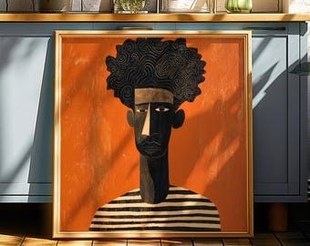 May include: Framed artwork featuring a stylized portrait of a person with dark skin and a large afro. The figure is depicted against an orange background, wearing a black and white striped shirt. The artwork is in a gold frame.