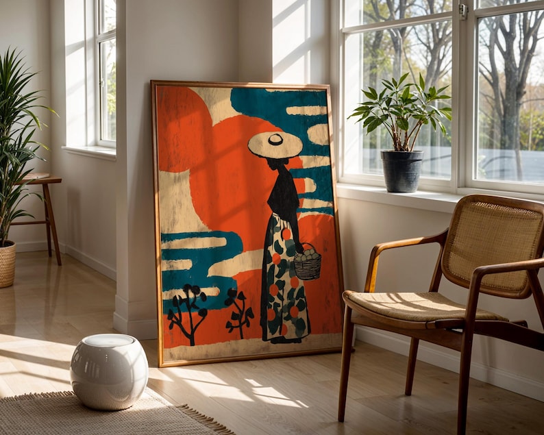 a large, colorful painting of a woman in a hat and dress, standing in front of a window with a potted plant on the sill. The painting is framed and placed on a wooden floor, with a woven chair nearby.