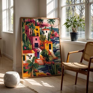 a vibrant, colorful painting of a tropical landscape, with palm trees, buildings, and water, displayed in a room with a large window and a woven chair.